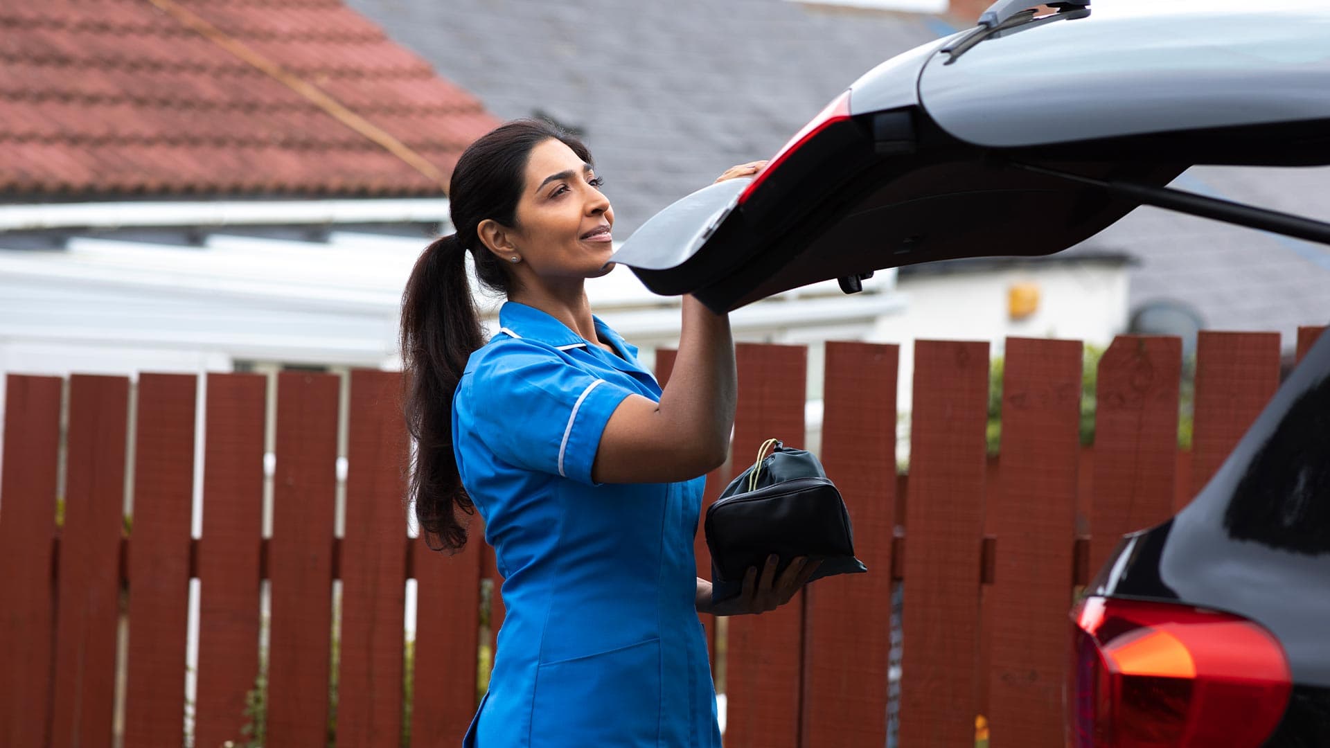 A travel nurse at home packing up her car on the way to the hospital