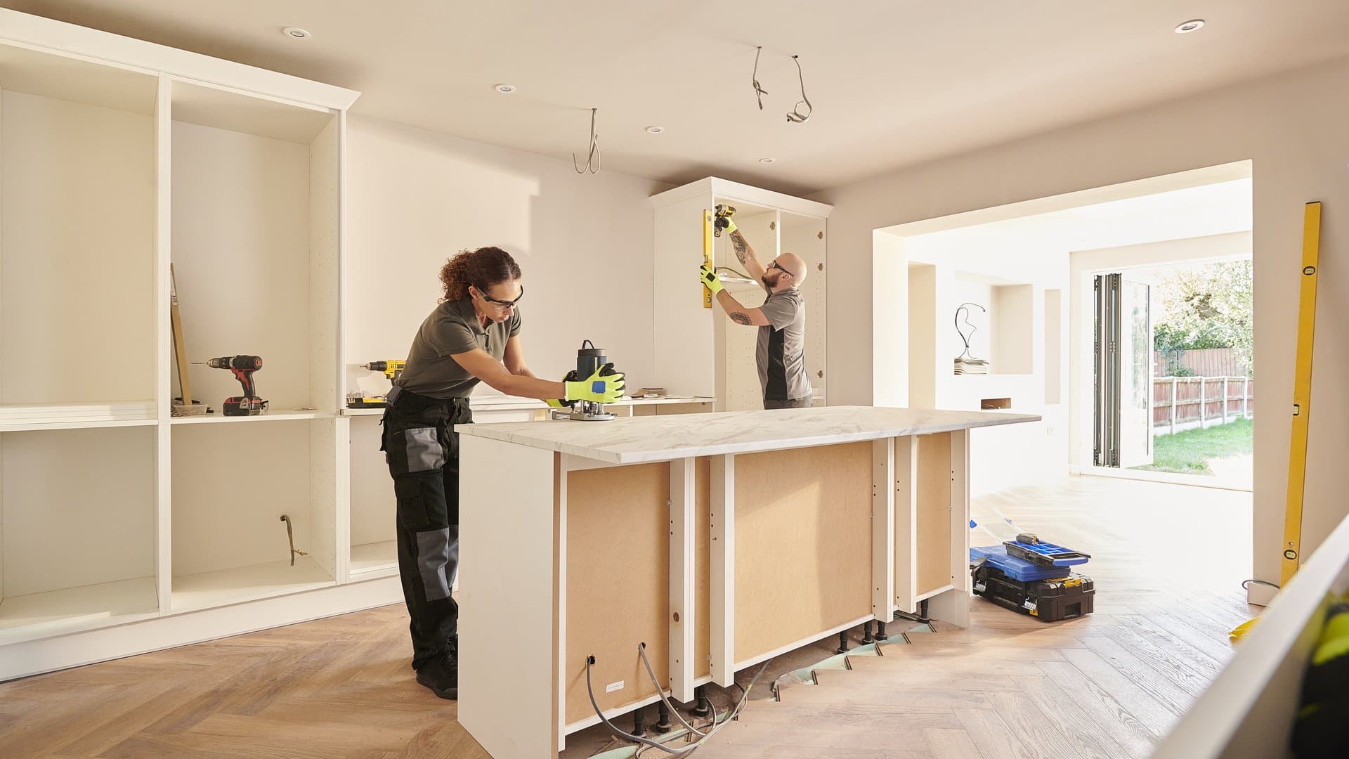 Kitchen fitters installing new cabinets during home remodel