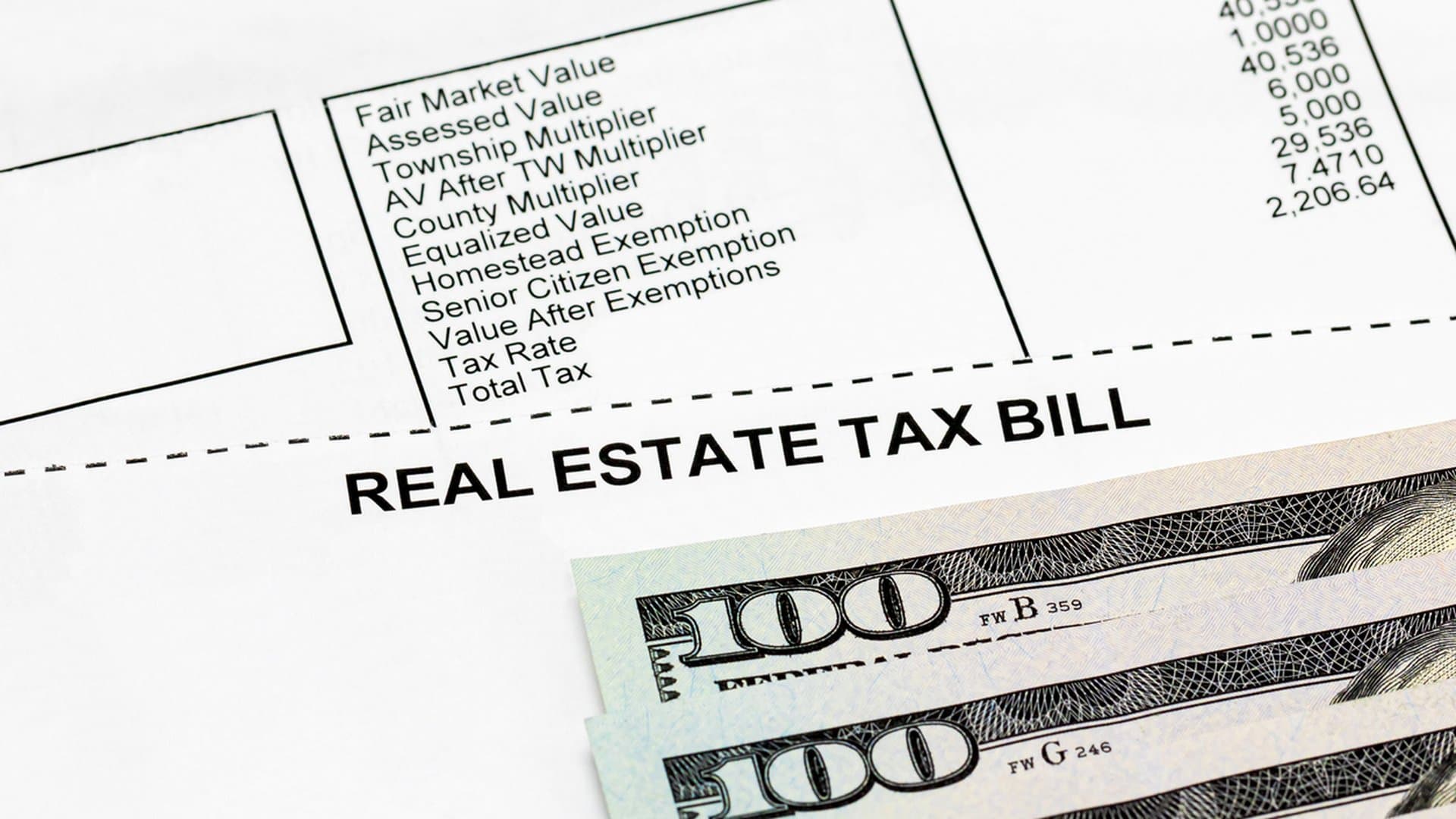 Property tax bill with cash, illustrating tax deferral versus reverse mortgage tradeoffs