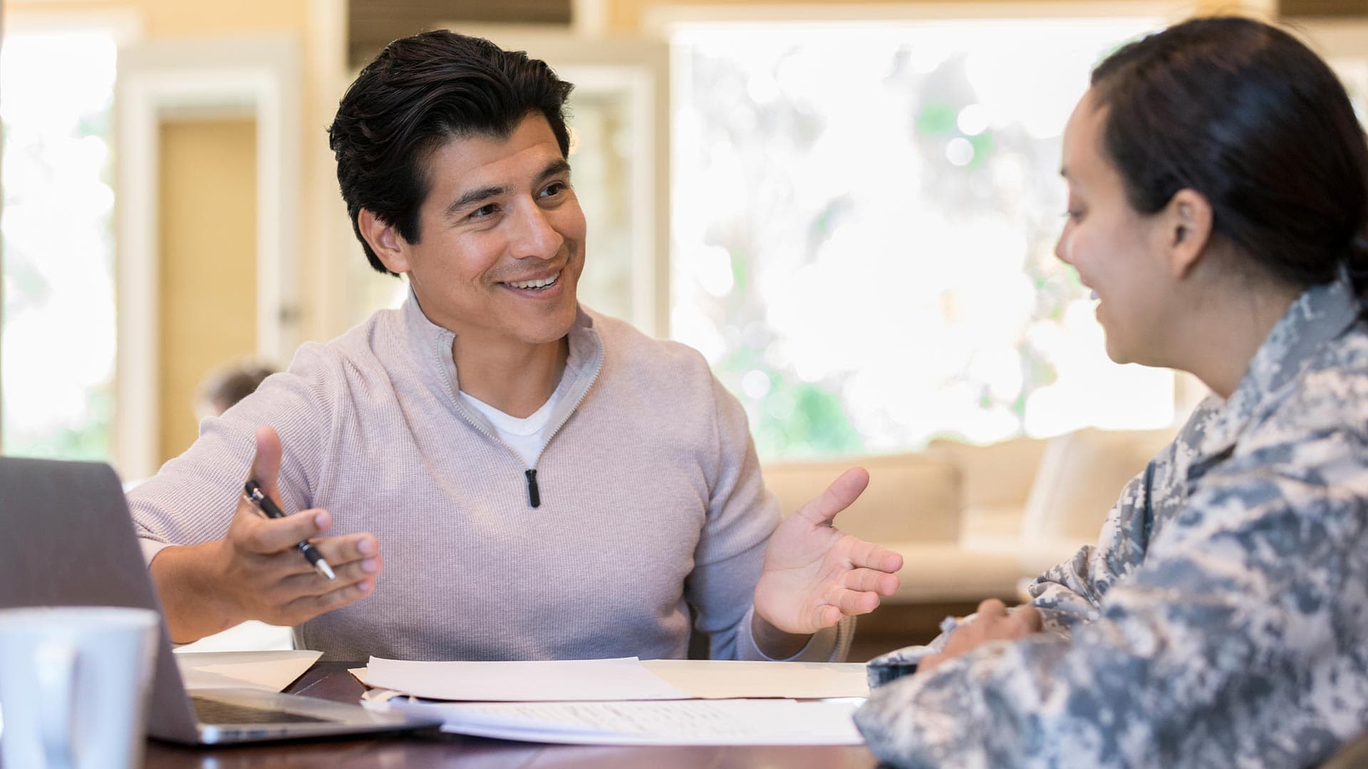 A mortgage loan officer talks to a veteran about their refinance options